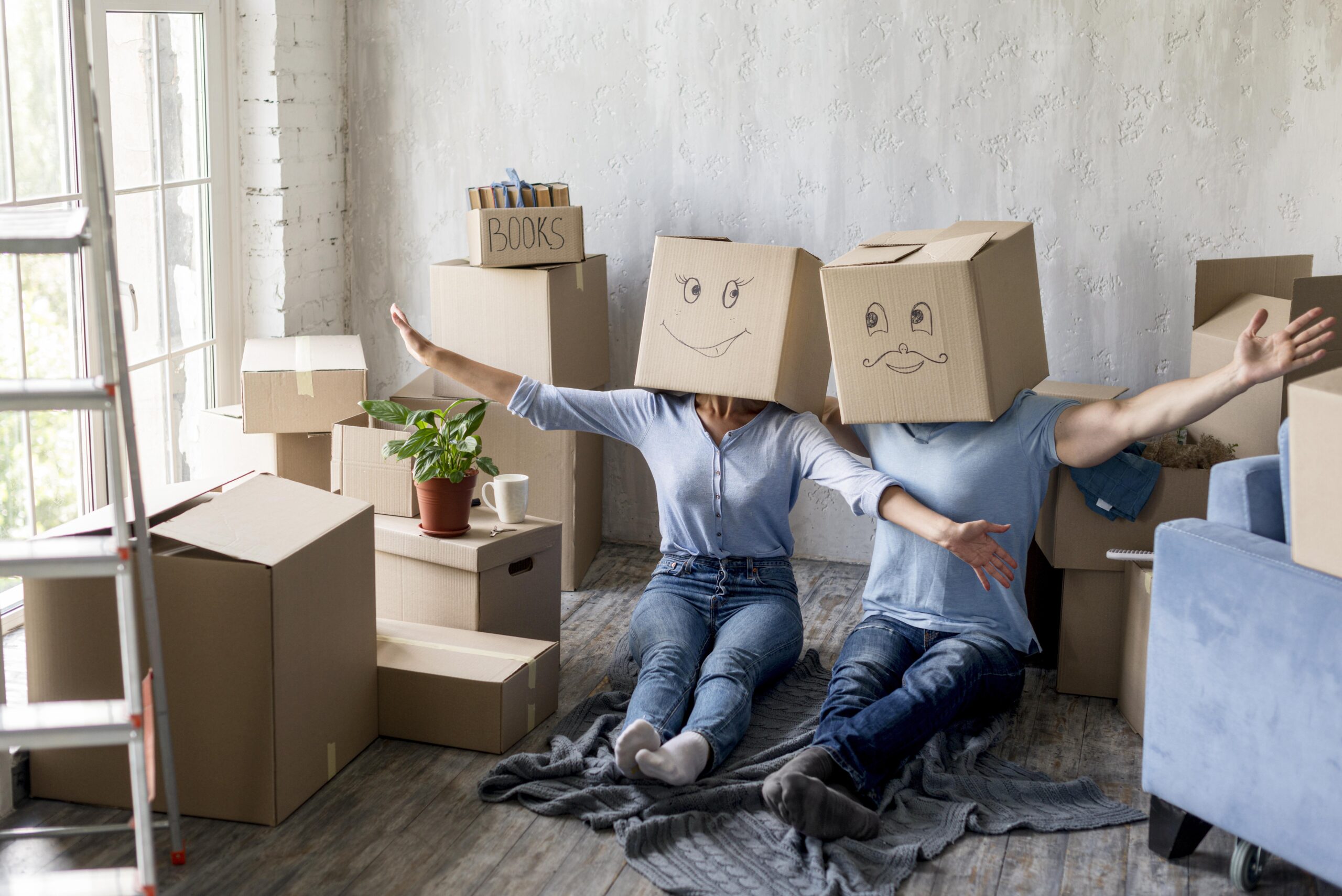 couple-home-moving-day-with-boxes-heads